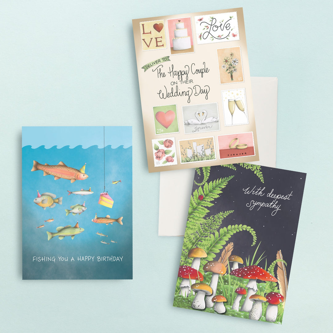 Three greeting cards: one with fish saying Fishing You a Happy Birthday, a wedding-themed collage card, and a sympathy card with mushrooms and ferns on a dark background. Envelopes included.